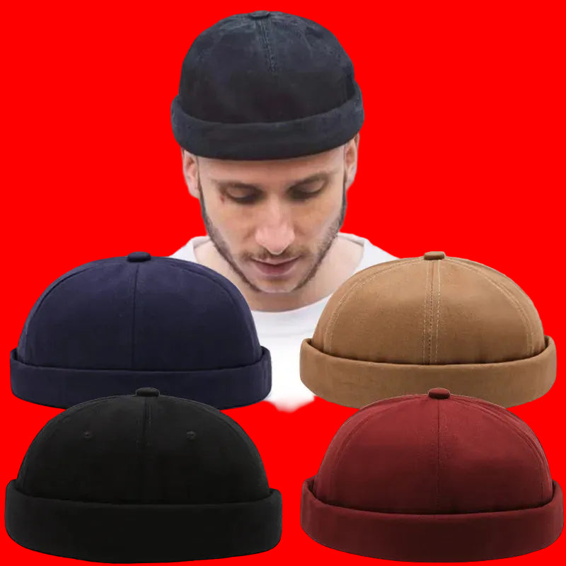 Man wearing a navy beanie with four additional beanies displayed in front of him.